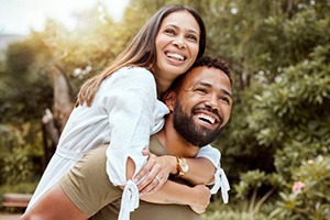 Happy couple with nice teeth enjoying recreation outdoors