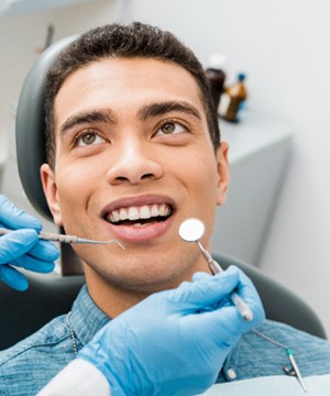 man smiling while visiting dentist near Shrewsbury