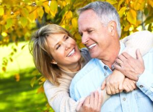 Good-looking older couple embracing outdoors